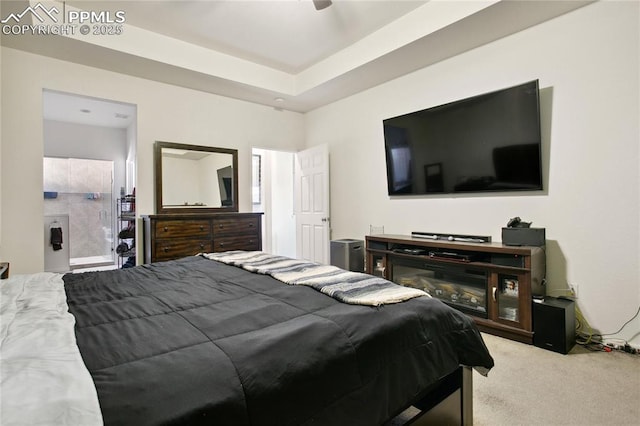 bedroom featuring carpet floors and a tray ceiling