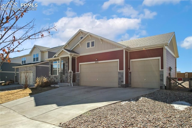 craftsman inspired home with an attached garage, concrete driveway, stone siding, roof with shingles, and board and batten siding