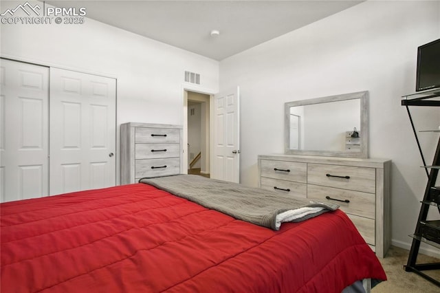 carpeted bedroom with baseboards, visible vents, and a closet