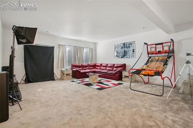 carpeted living room with baseboards and beamed ceiling