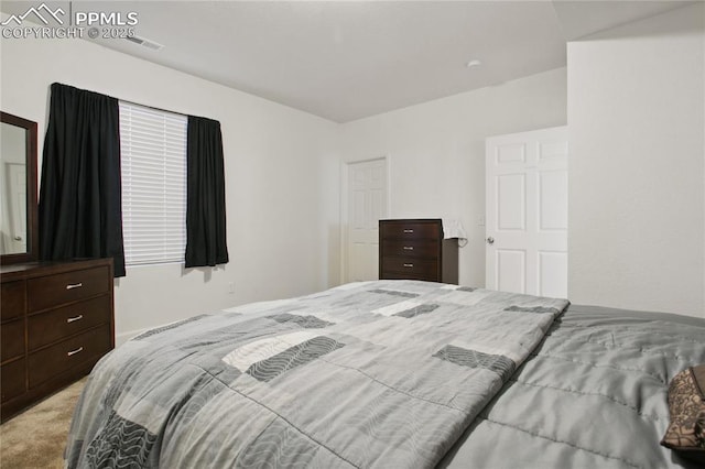 carpeted bedroom featuring visible vents