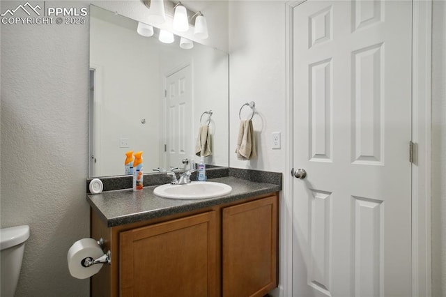 half bath with vanity and toilet