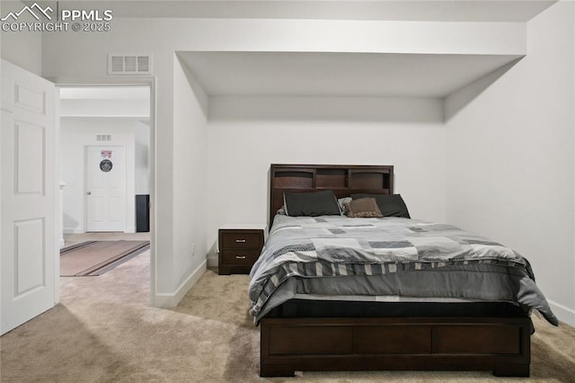 carpeted bedroom with visible vents and baseboards