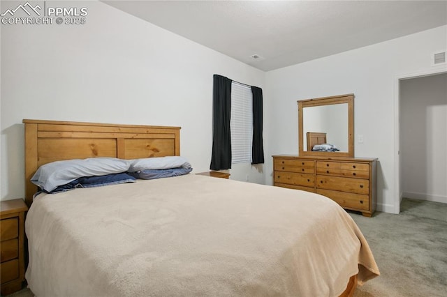 carpeted bedroom featuring visible vents and baseboards