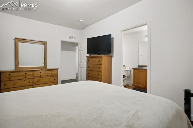 bedroom with visible vents and connected bathroom