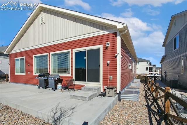 back of house with entry steps, a patio area, fence, and central air condition unit