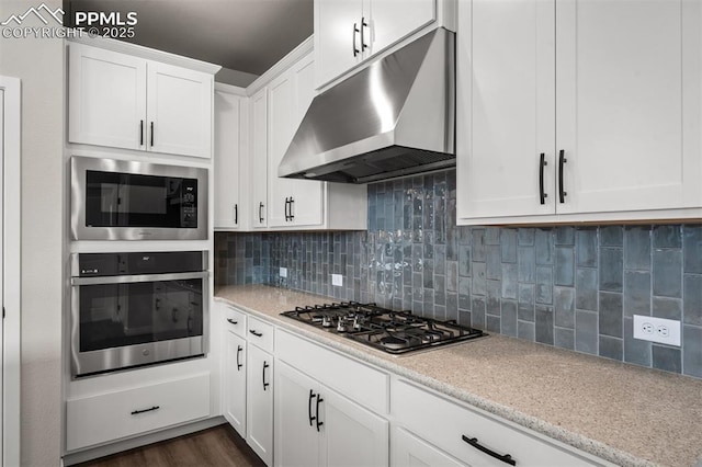 6395 Laud Pt, Colorado Springs, CO 80924 - kitchen featuring stainless steel appliances, under cabinet range hood, white cabinets, and tasteful backsplash