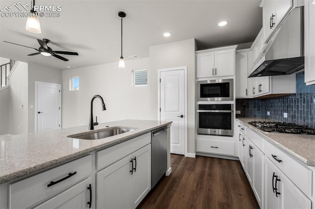 6395 Laud Pt, Colorado Springs, CO 80924 - kitchen featuring stainless steel appliances, a sink, under cabinet range hood, ceiling fan, and dark wood-type flooring