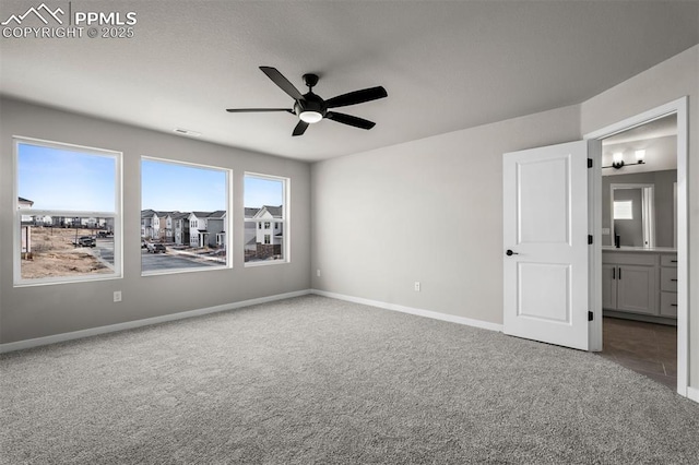 6395 Laud Pt, Colorado Springs, CO 80924 - unfurnished bedroom featuring carpet flooring, baseboards, ceiling fan, and ensuite bathroom