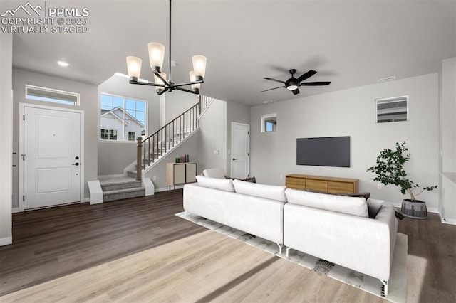 6395 Laud Pt, Colorado Springs, CO 80924 - living room with stairway, wood finished floors, baseboards, a chandelier, and a ceiling fan