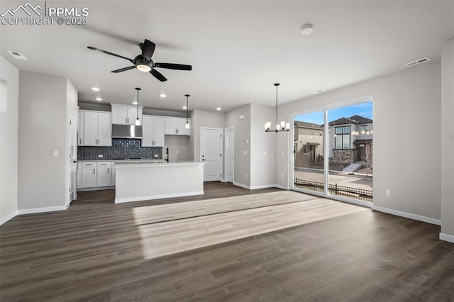 6395 Laud Pt, Colorado Springs, CO 80924 - kitchen featuring baseboards, under cabinet range hood, open floor plan, a chandelier, and recessed lighting