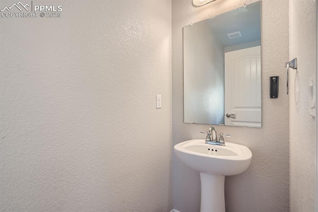 bathroom with a textured wall