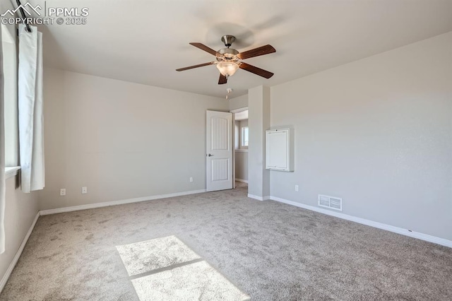 unfurnished bedroom with baseboards, visible vents, ceiling fan, and carpet flooring