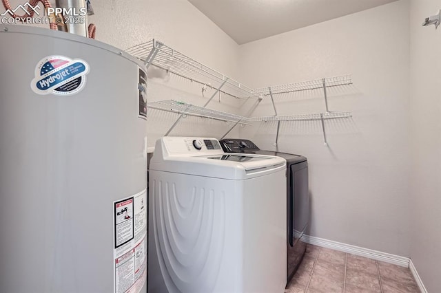 laundry room featuring washer and dryer, laundry area, electric water heater, and baseboards