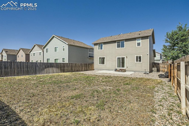 rear view of property with a yard, a patio area, a fenced backyard, and a residential view