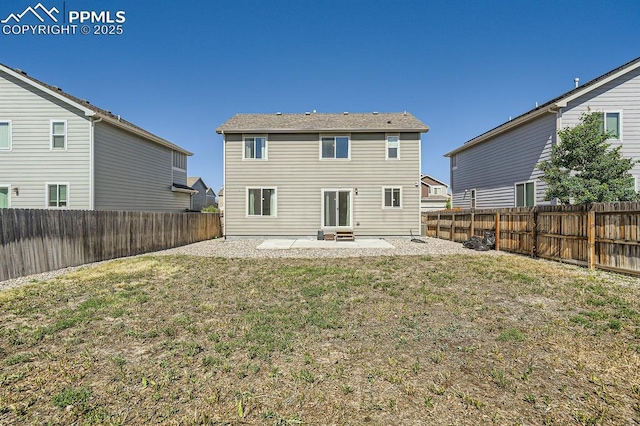 rear view of property with entry steps, a patio area, a fenced backyard, and a yard