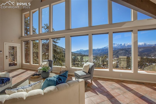 unfurnished sunroom with a mountain view