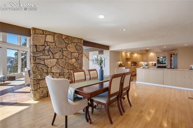 dining room featuring light wood-type flooring and recessed lighting