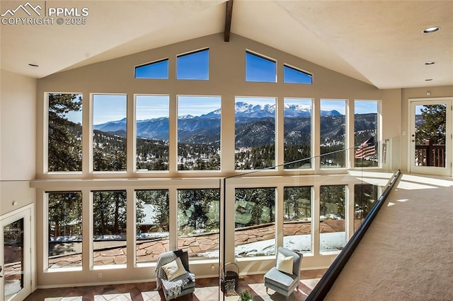 unfurnished sunroom with a mountain view and lofted ceiling with beams