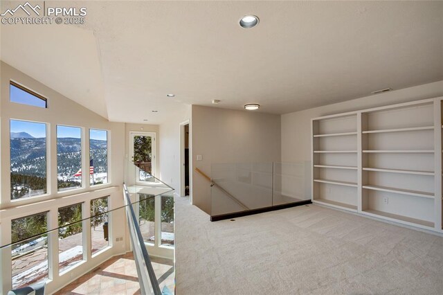 interior space featuring recessed lighting, vaulted ceiling, visible vents, and a mountain view