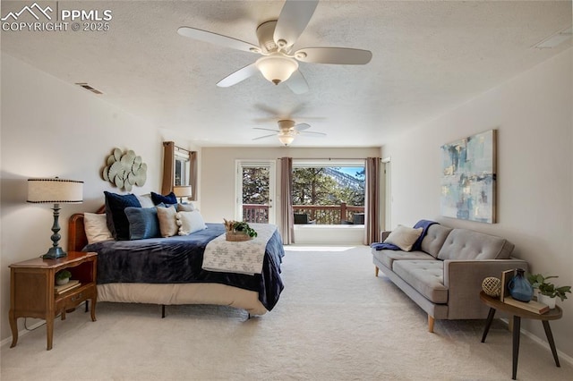 bedroom featuring visible vents, a ceiling fan, a textured ceiling, and light colored carpet