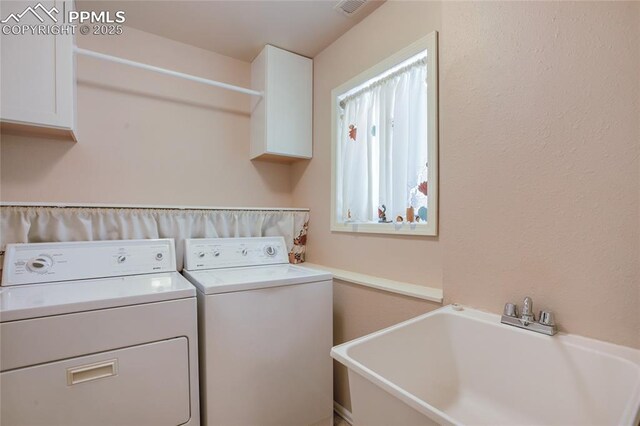 laundry room with laundry area, a sink, and independent washer and dryer