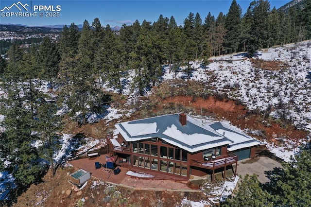 snowy aerial view with a view of trees