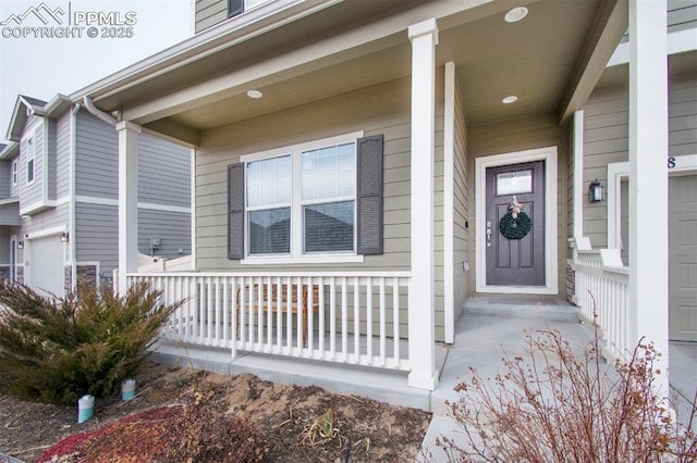 doorway to property featuring a garage and covered porch