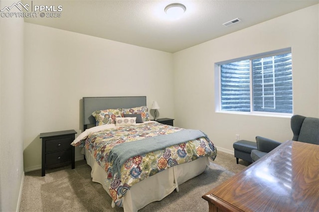 bedroom featuring baseboards, visible vents, and carpet floors