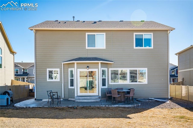 back of property featuring a patio and fence