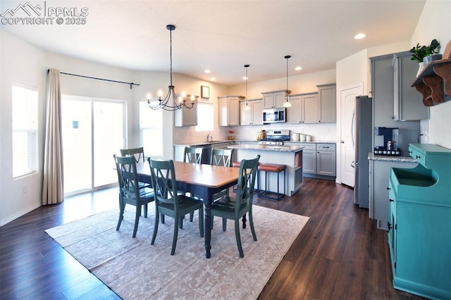 dining space featuring a notable chandelier, recessed lighting, baseboards, and dark wood-style flooring