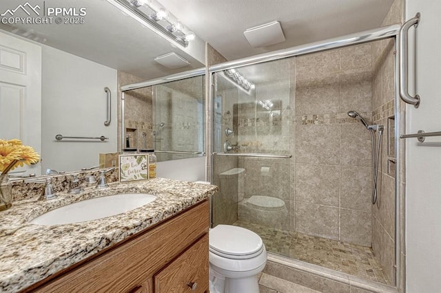 full bath featuring a shower stall, toilet, and vanity