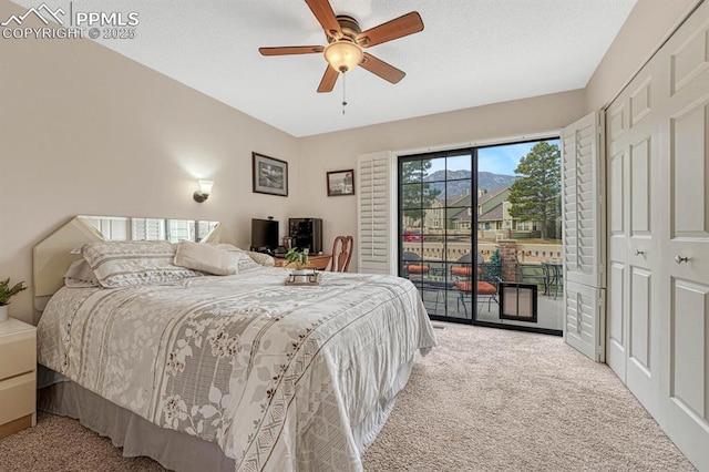 bedroom with a textured ceiling, carpet flooring, a ceiling fan, and access to exterior