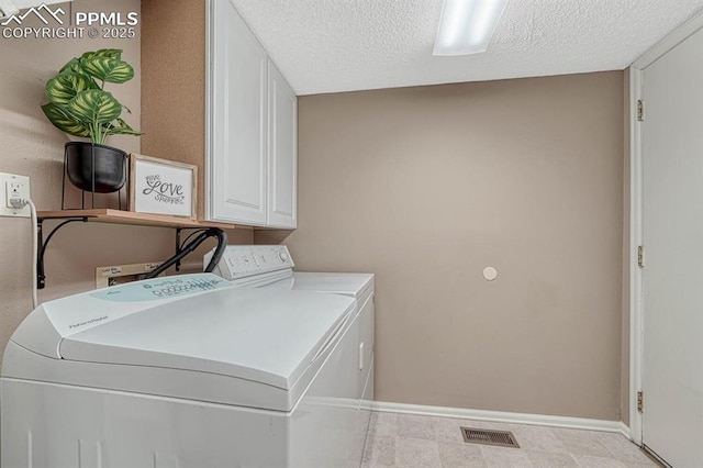 laundry room with a textured ceiling, visible vents, baseboards, washer and dryer, and cabinet space