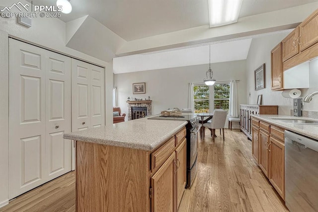 kitchen with black range with electric cooktop, a fireplace, a sink, light wood-style floors, and dishwasher