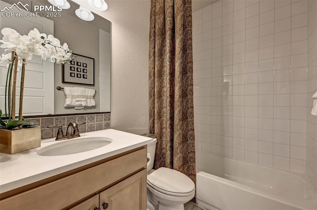 bathroom featuring a textured wall, shower / bath combo, vanity, and toilet