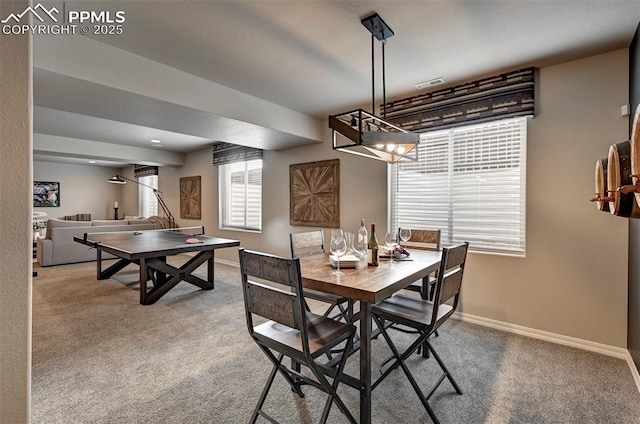 carpeted dining room with baseboards and visible vents