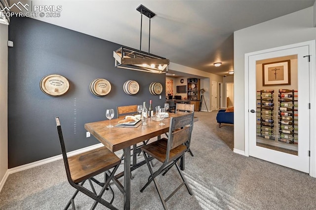 dining room featuring carpet floors and baseboards