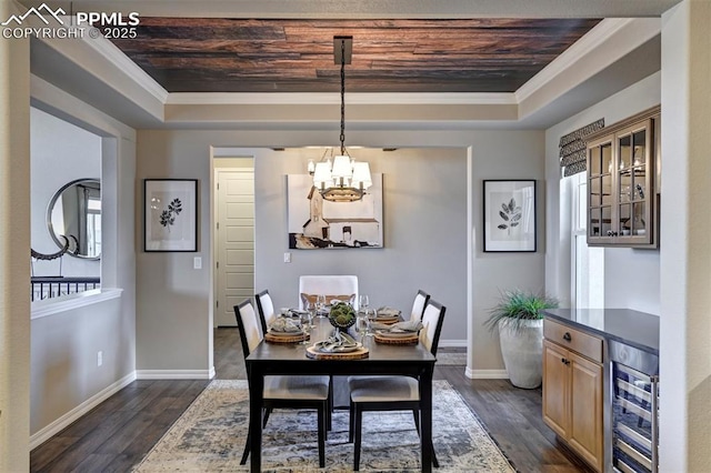 dining room with beverage cooler, wood ceiling, a tray ceiling, dark wood finished floors, and crown molding