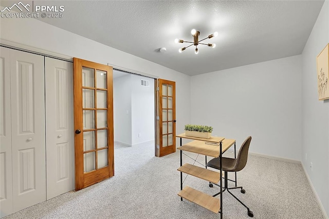 carpeted home office with french doors, visible vents, an inviting chandelier, a textured ceiling, and baseboards