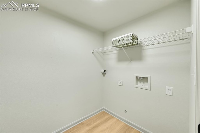 laundry area with hookup for a washing machine, light wood-style floors, electric dryer hookup, laundry area, and baseboards