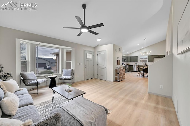 living room featuring light wood-style floors, recessed lighting, vaulted ceiling, and ceiling fan with notable chandelier