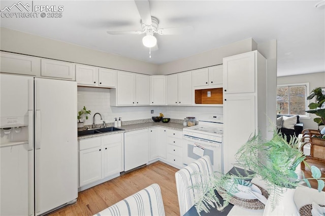 4127 Bent Dr, Colorado Springs, CO 80909 - kitchen featuring white cabinets, a sink, and white appliances