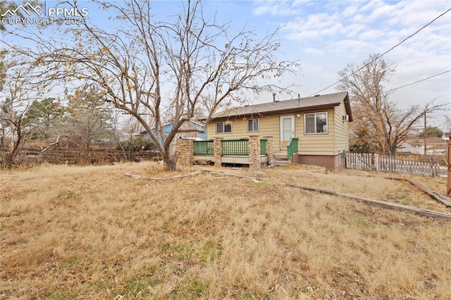 4127 Bent Dr, Colorado Springs, CO 80909 - back of house featuring fence and a deck