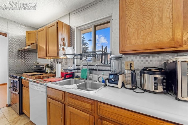 kitchen with light countertops, white dishwasher, a sink, double oven range, and under cabinet range hood