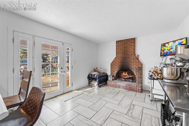 living room with a textured ceiling and a fireplace