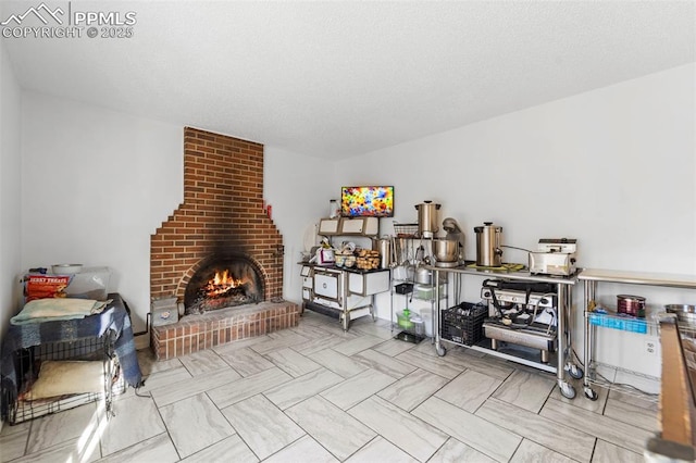 game room with a textured ceiling and a brick fireplace