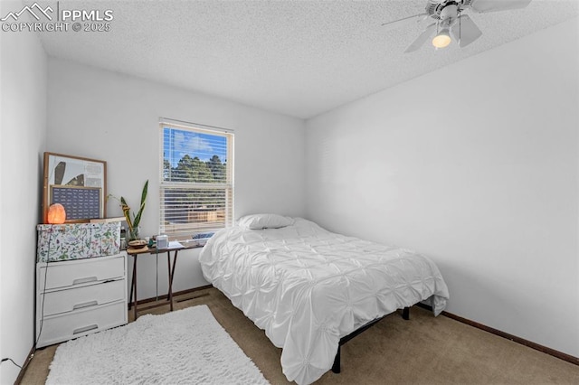 carpeted bedroom with a textured ceiling, a ceiling fan, and baseboards