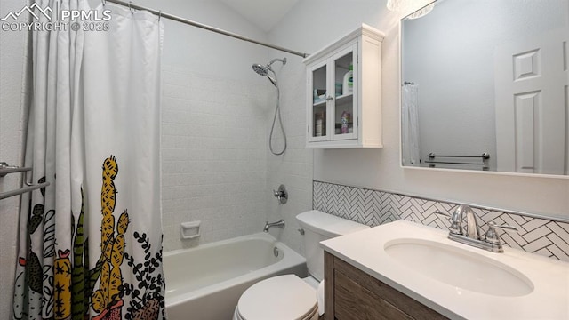 bathroom featuring shower / tub combo, wainscoting, vanity, and toilet