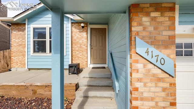 property entrance featuring brick siding